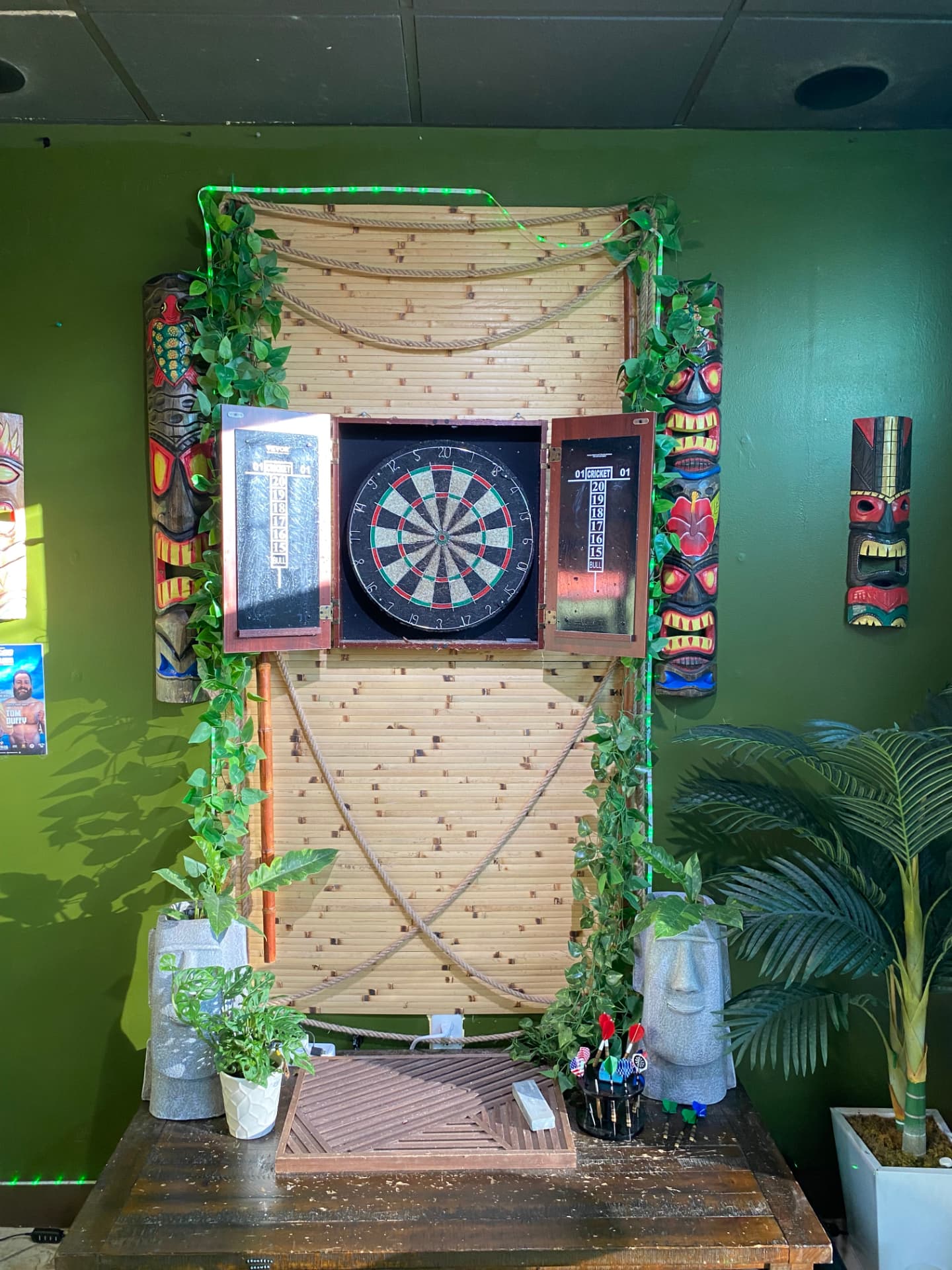 Tiki-decorated dartboard station at Root Awakening Kava Bar